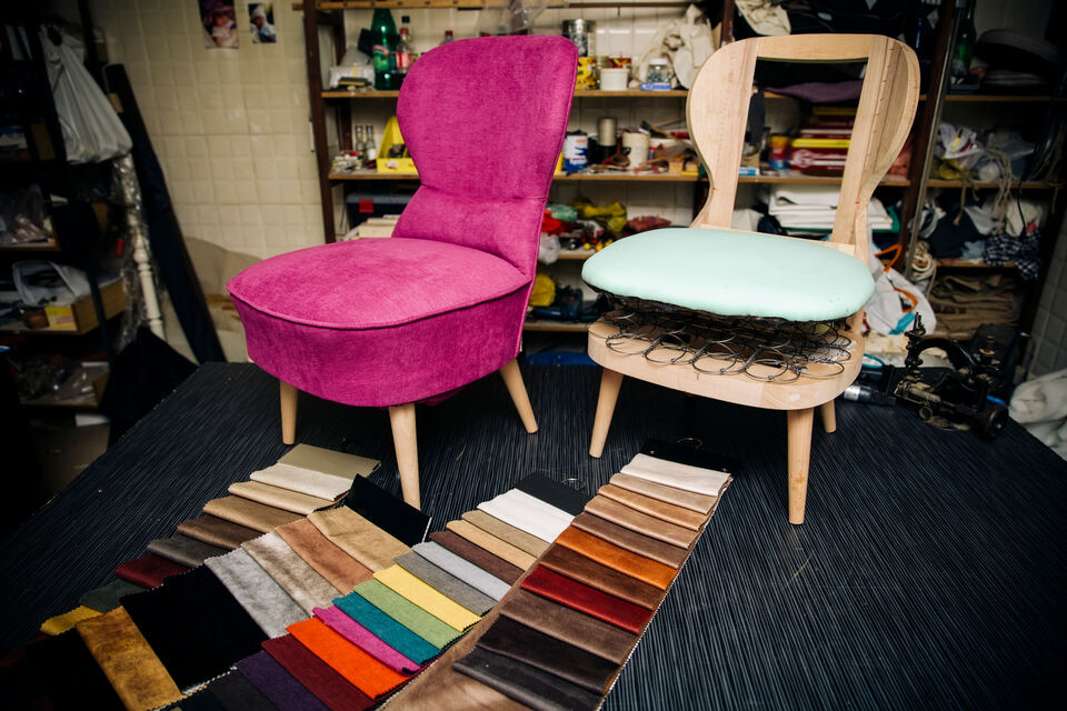 Silla tapizada con un material rosa y otra sin tapizar